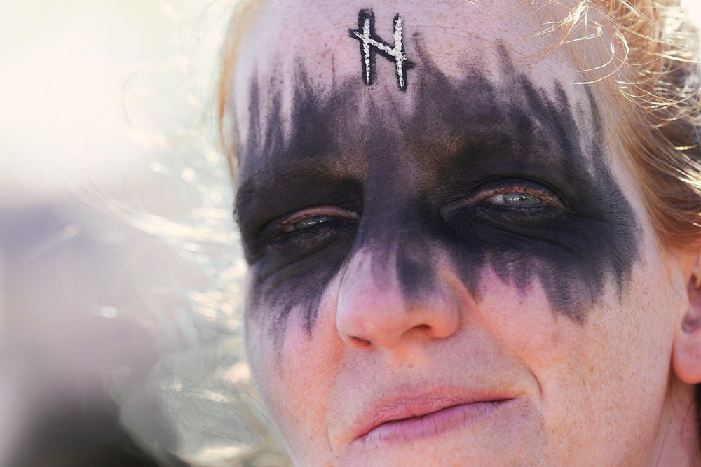 man with black hair and face paint