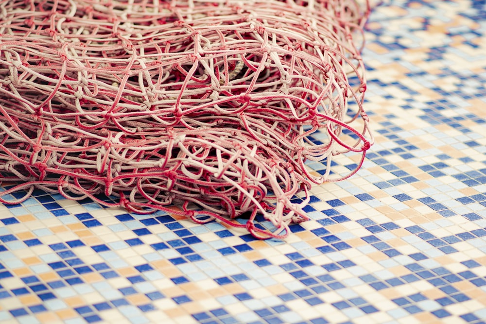 red and white yarn on blue and white checkered textile