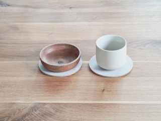 Hand-carved wooden bowls paired with leather coasters.