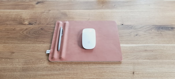 A close-up of a sleek mouse pad on a modern desk setup.