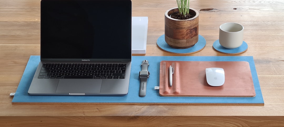 macbook pro on brown wooden table