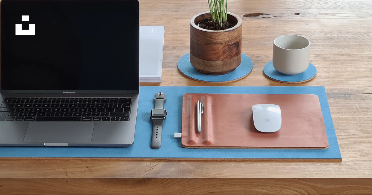 Macbook pro on brown wooden table photo – Free Blue Image on Unsplash