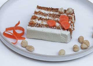 sliced cake with sliced strawberry on white ceramic plate