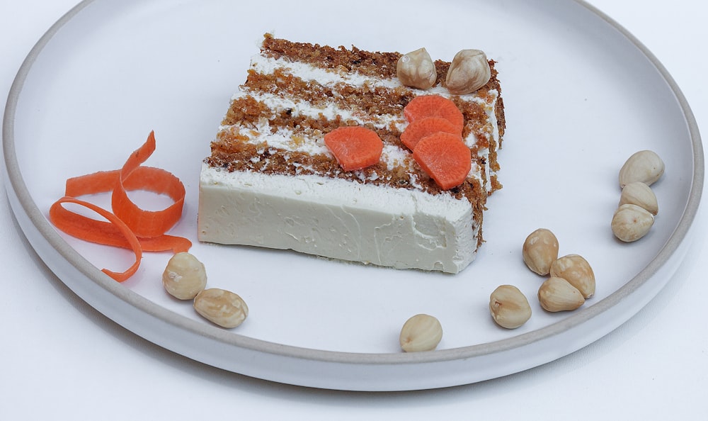 sliced cake with sliced strawberry on white ceramic plate