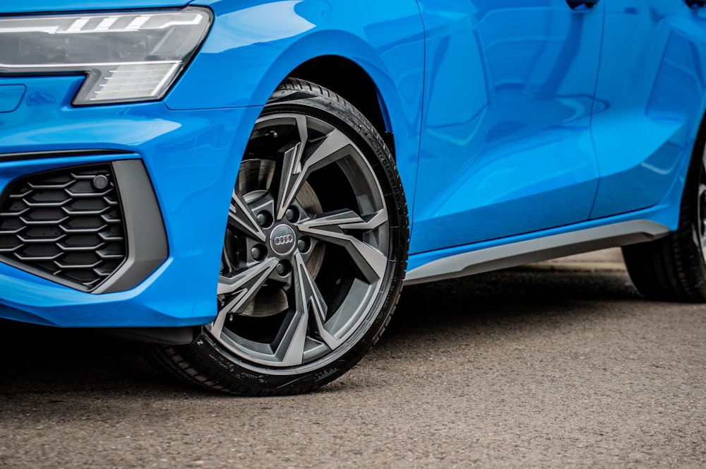 blue car on gray asphalt road