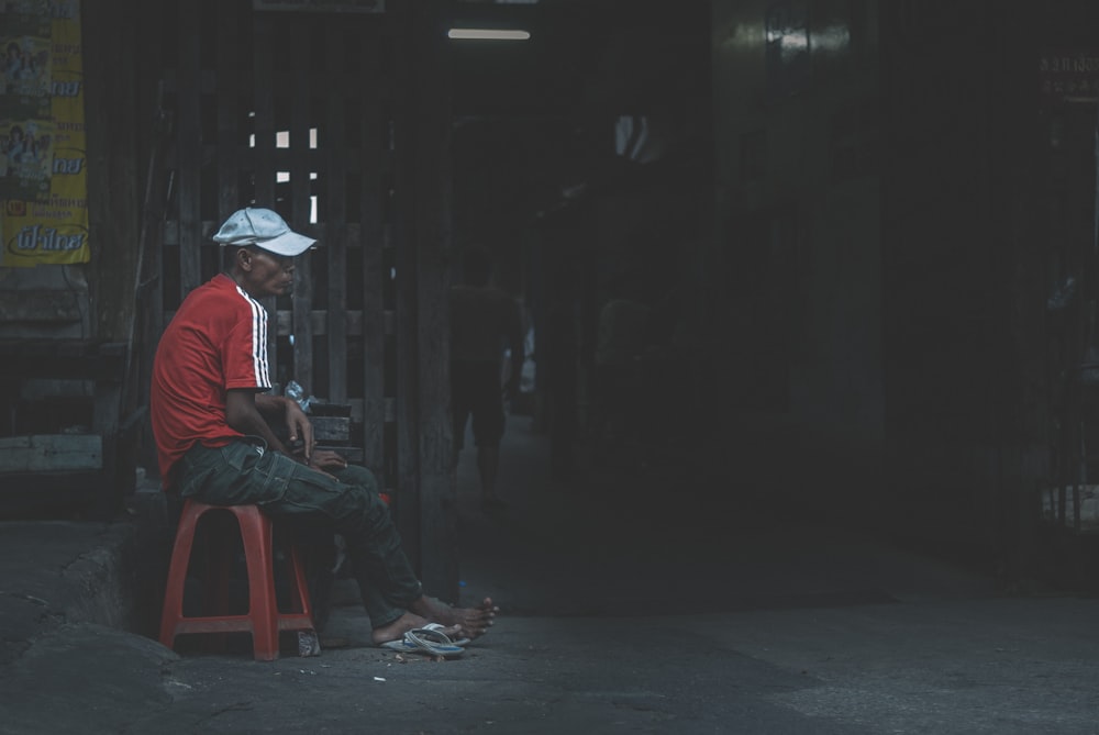 a man sitting on top of a red chair