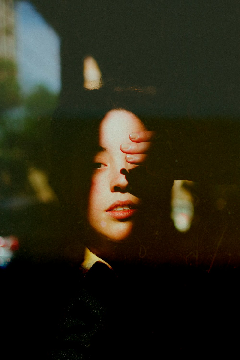 woman in black shirt looking at the window