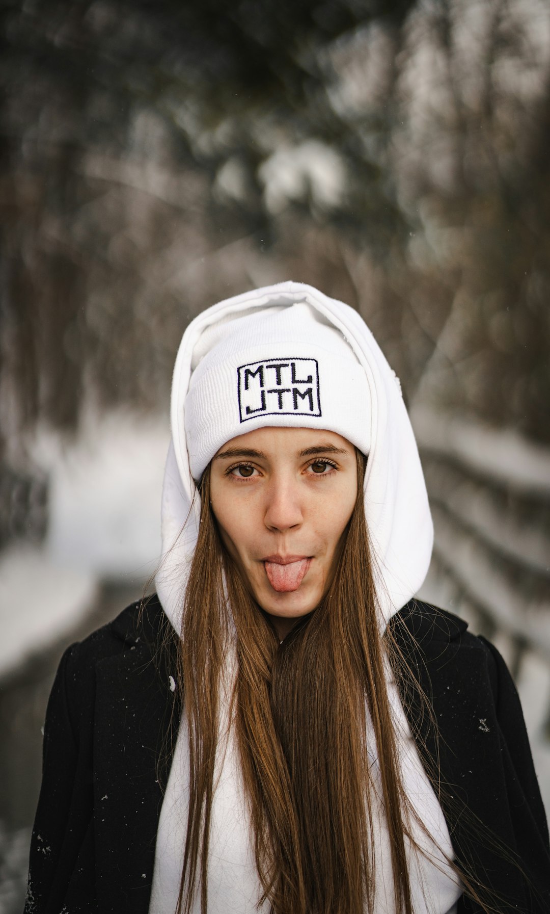 woman in white and black hoodie wearing white cap