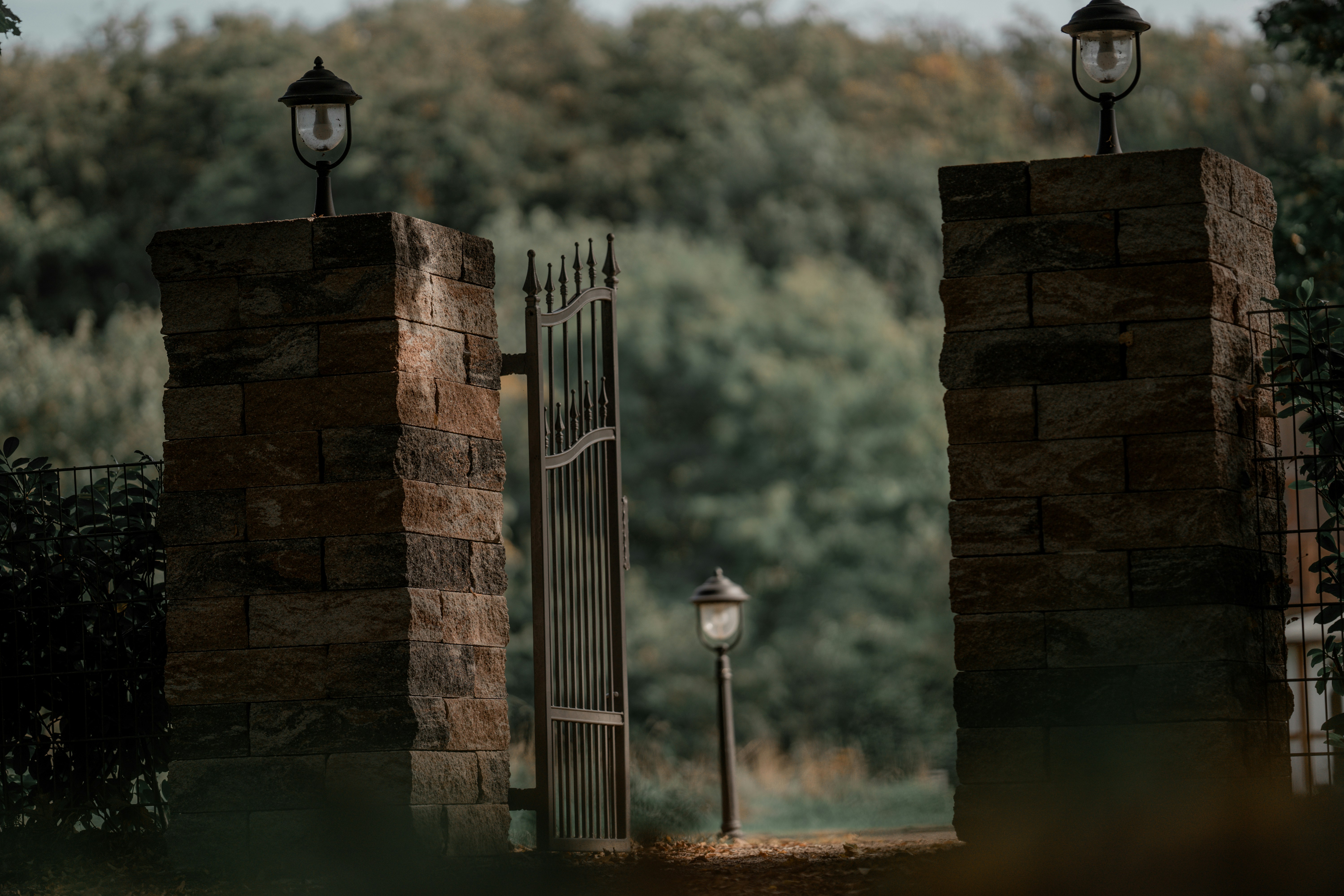 black steel lamp post near body of water during daytime