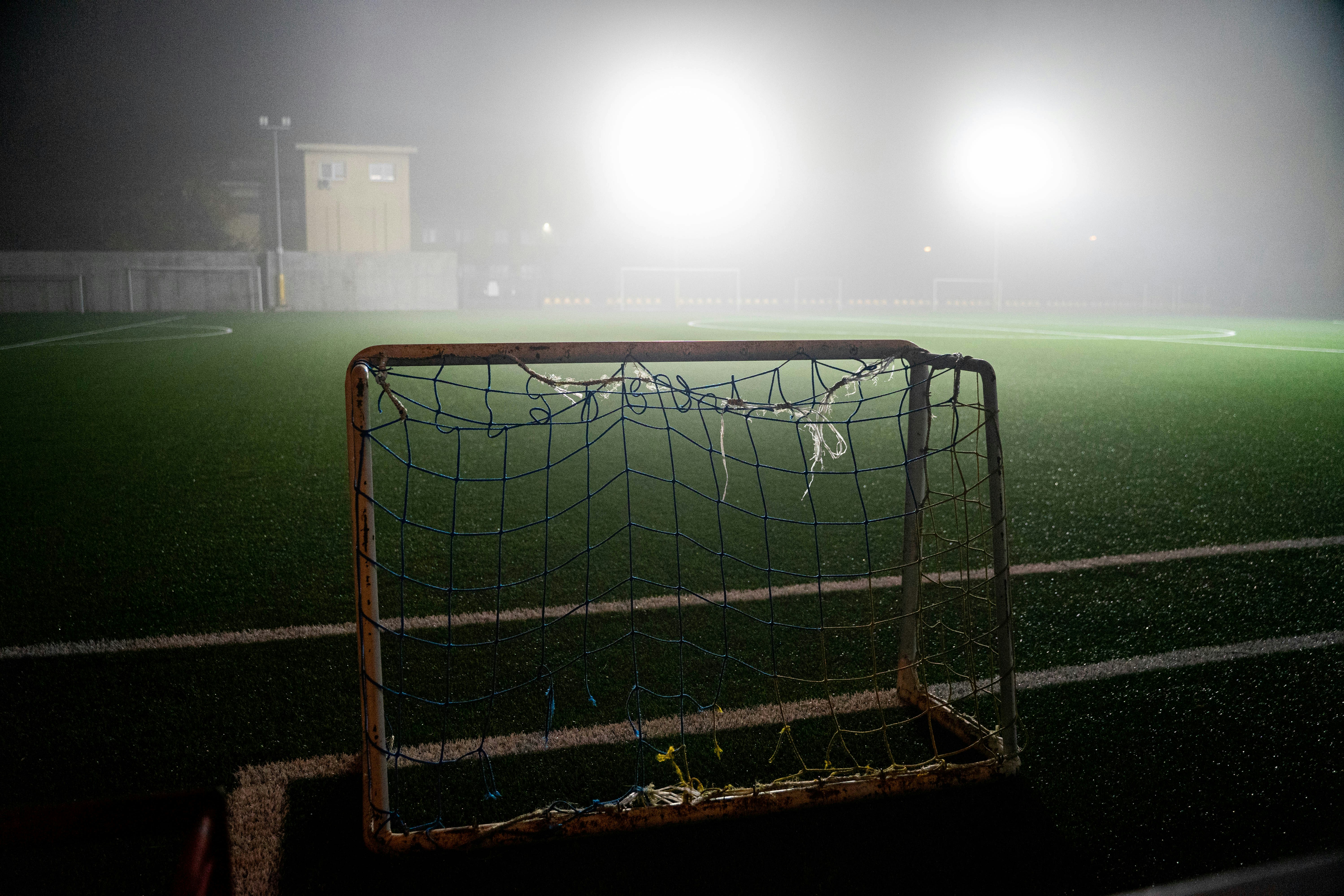 soccer goal net on field during night time
