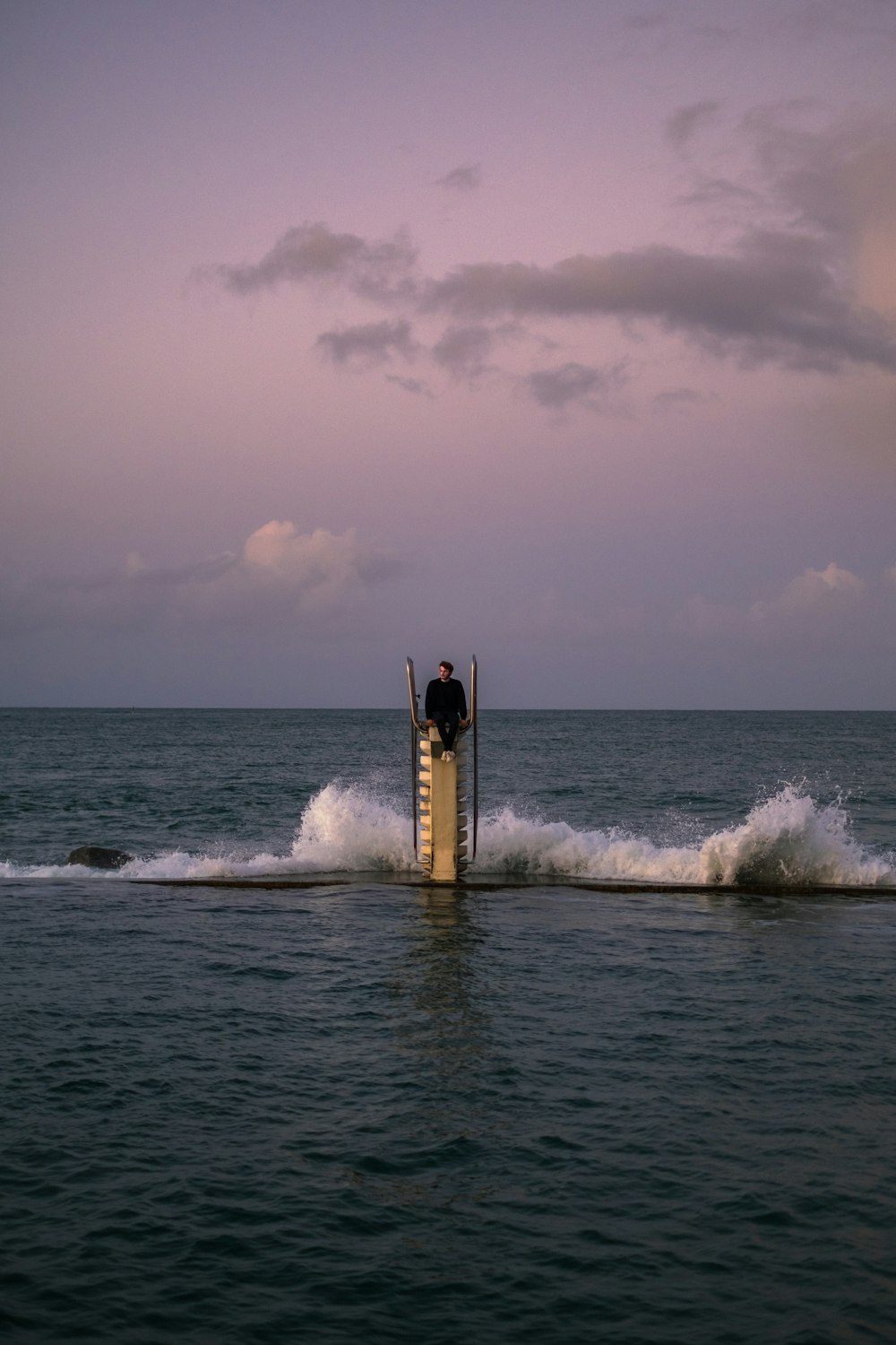 person surfing on sea waves during daytime