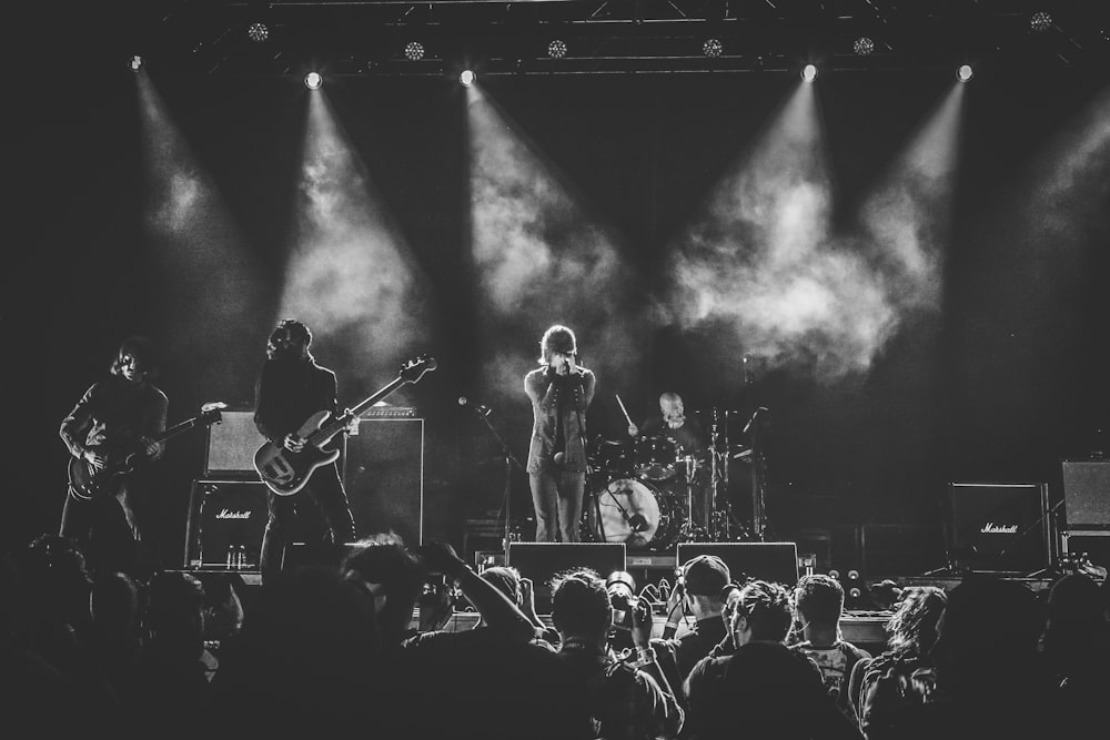 grayscale photo of band performing on stage