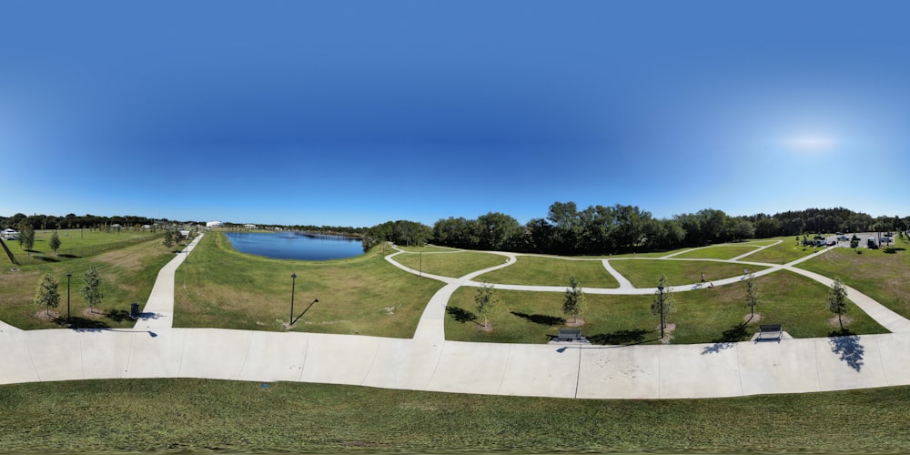 green grass field near body of water during daytime