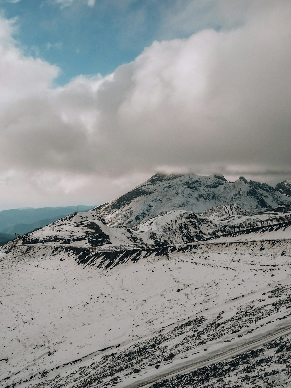 snow covered mountain under cloudy sky during daytime