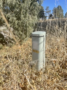A sturdy control box mounted on-site in the rugged Permian Basin landscape under a clear blue sky.