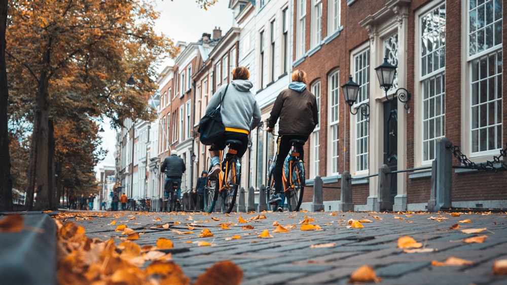 man in black jacket riding bicycle on road during daytime