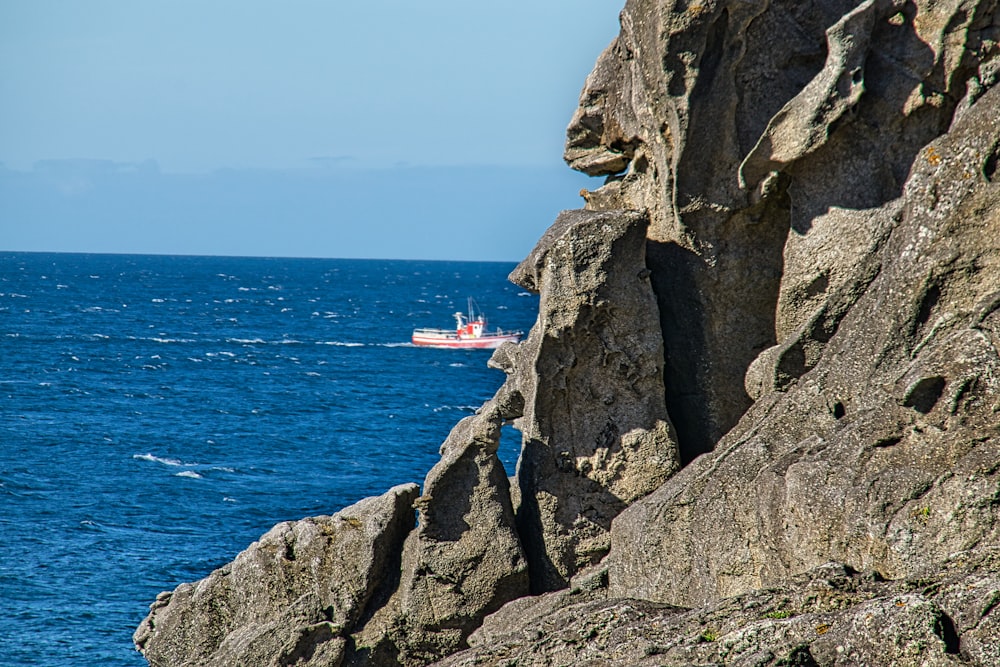 white and red boat on sea during daytime