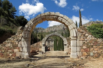 brown brick arch under blue sky during daytime