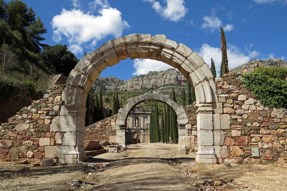 brown brick arch under blue sky during daytime