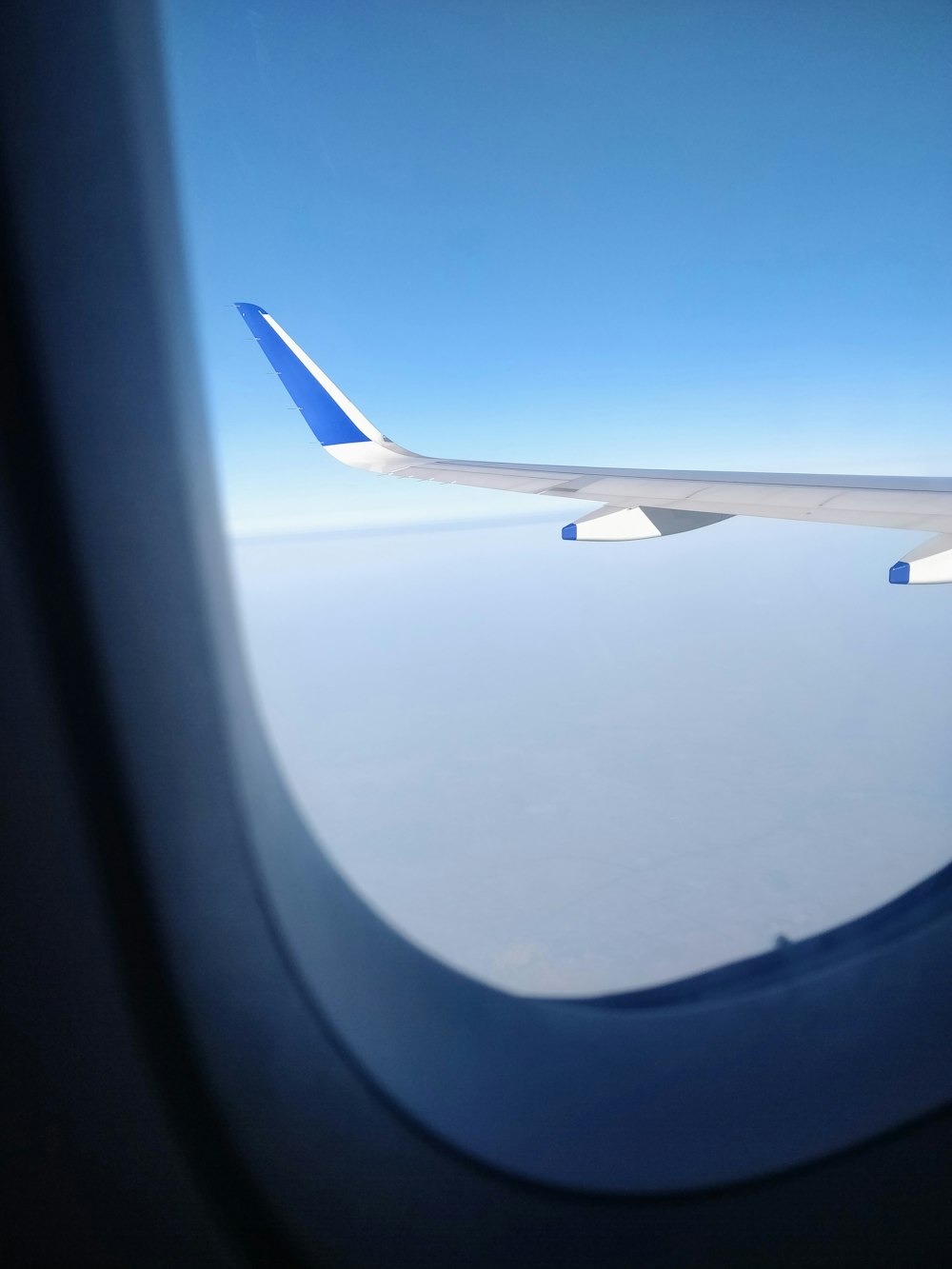 airplane window view of white clouds during daytime
