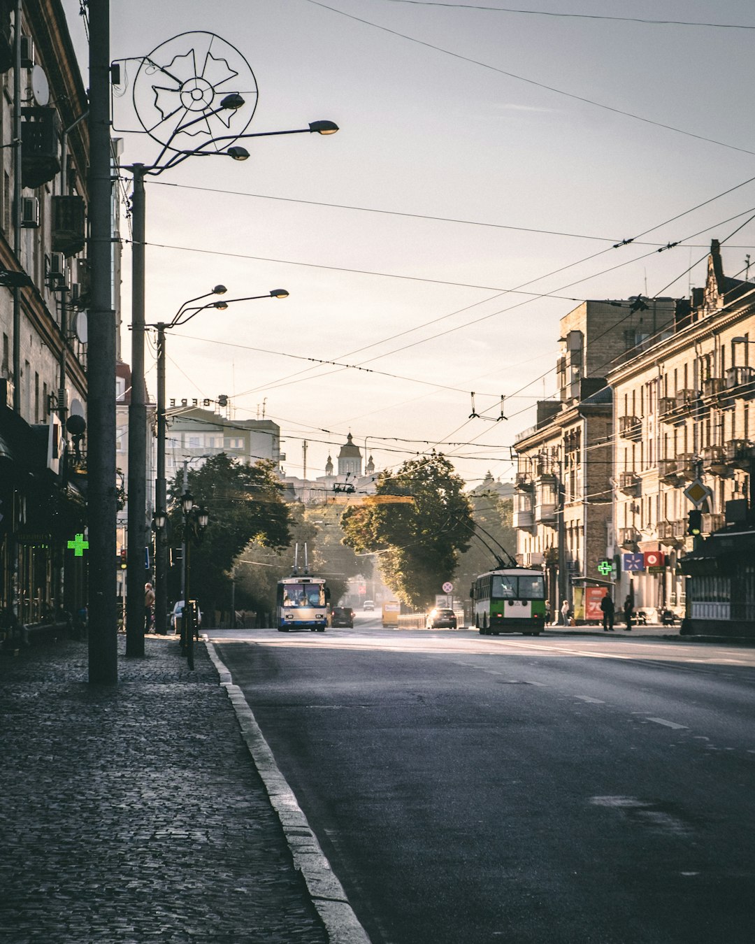 gray concrete road between buildings during daytime