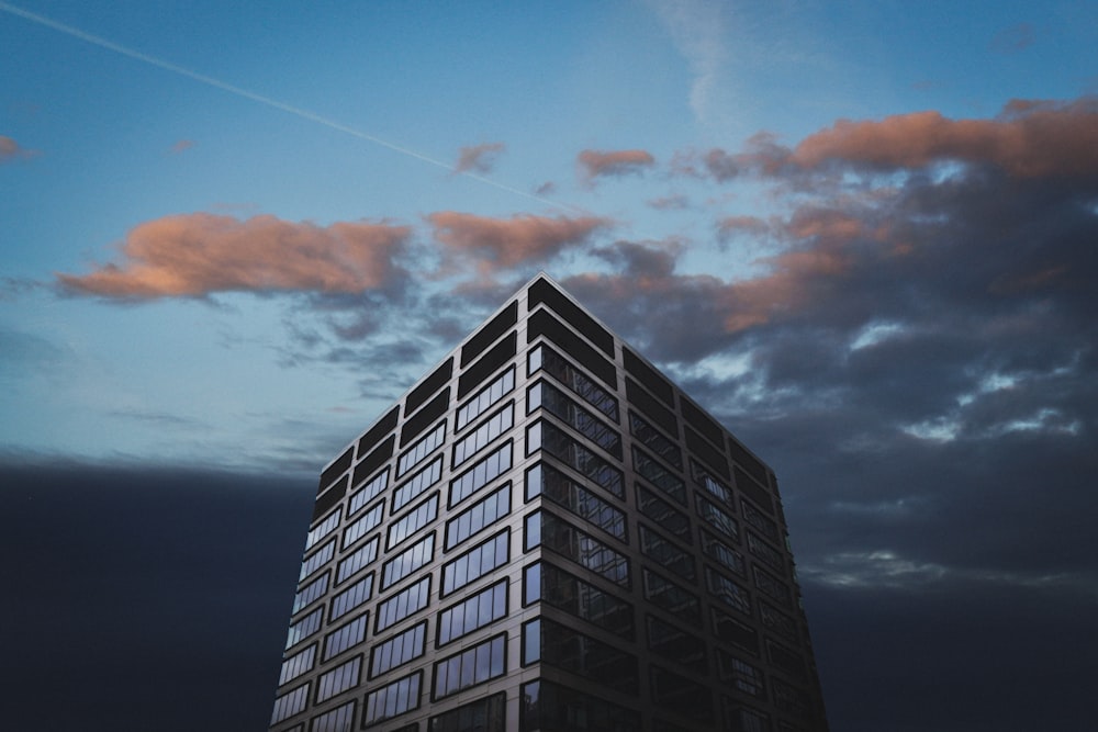 black and white building under cloudy sky during daytime