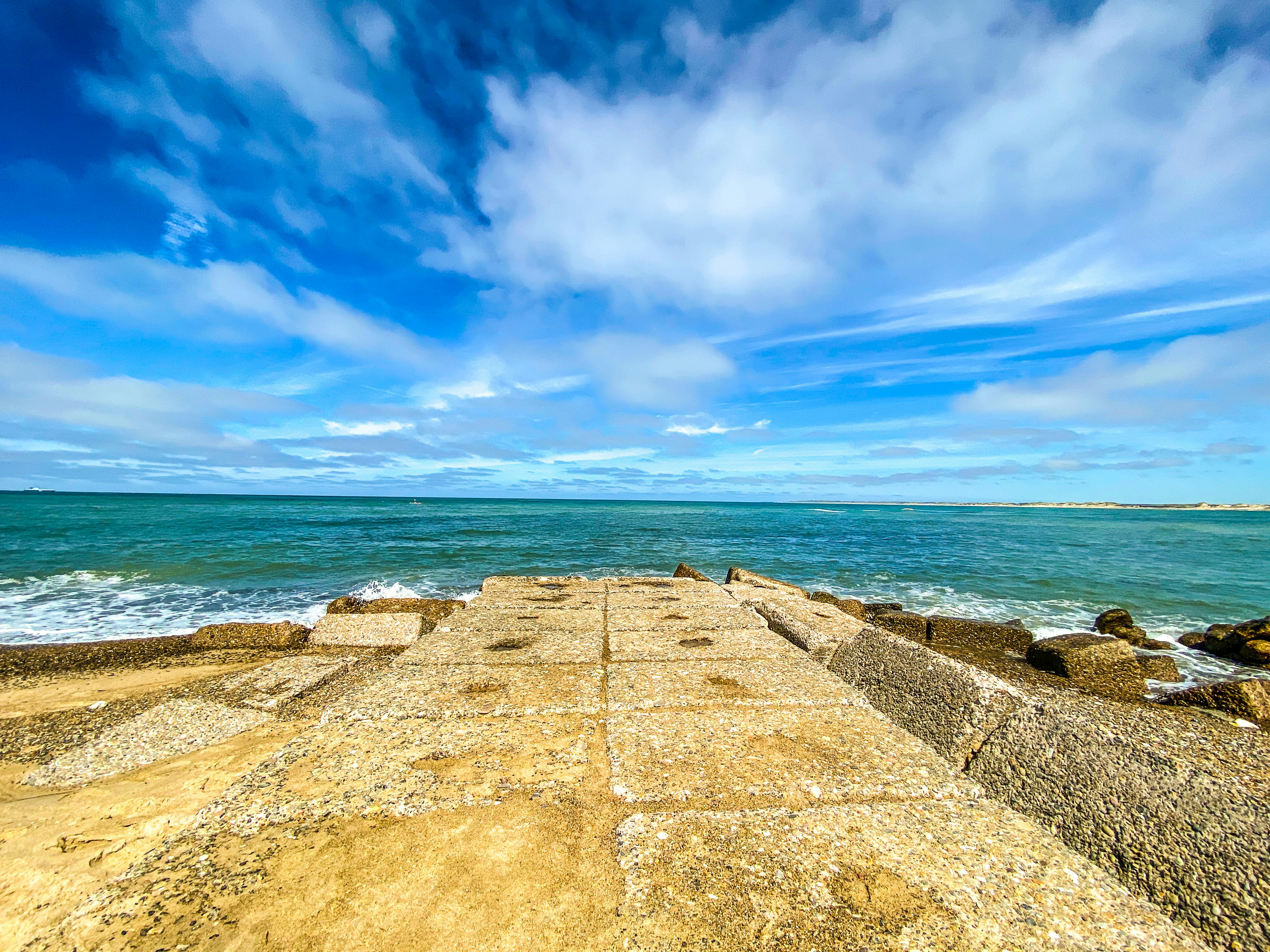 brown concrete pathway near sea under blue sky during daytime, View point