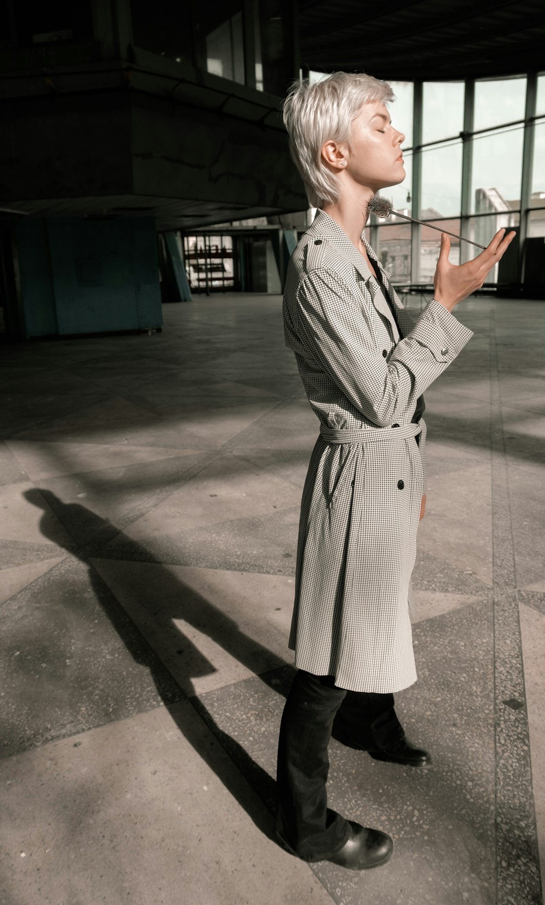 woman in white and black long sleeve dress standing on gray concrete floor