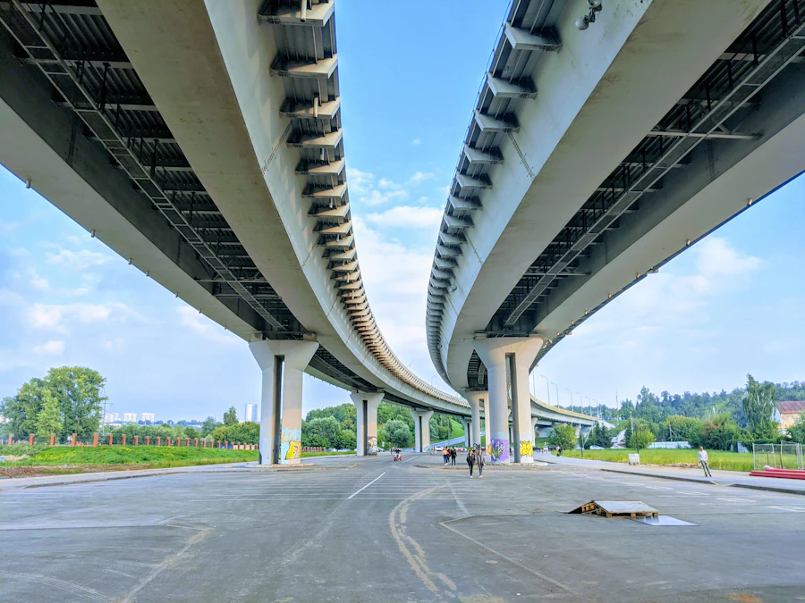 Curving elevated concrete highway interchange seen from below