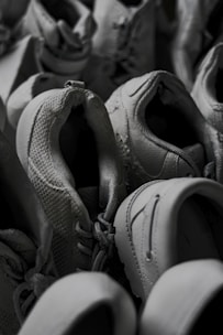 Casual men's sneakers arranged neatly on a concrete floor, showing details in stitching and laces
