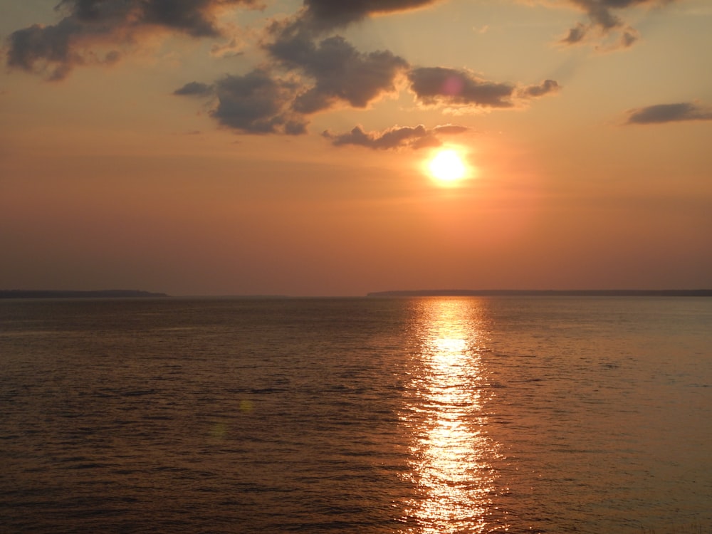 body of water during sunset