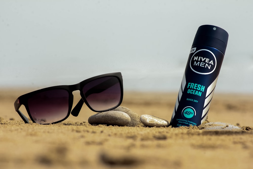 black sunglasses beside nivea men spray bottle