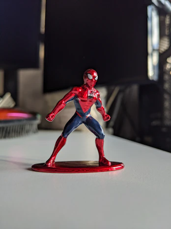 A close-up of a superhero figure with a glossy finish, capturing its dynamic pose.
