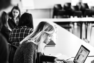 woman in black long sleeve shirt using laptop computer