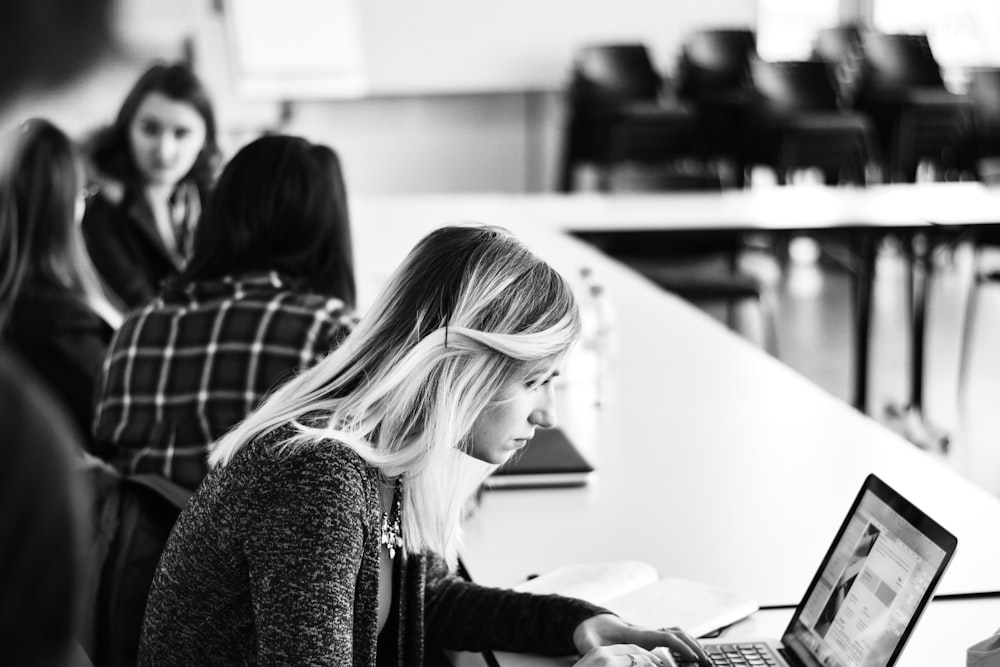 woman in black long sleeve shirt using laptop computer