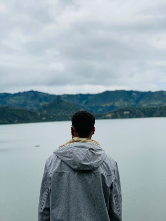 man in grey jacket standing near lake during daytime in Shewa Kifle Hager Ethiopia