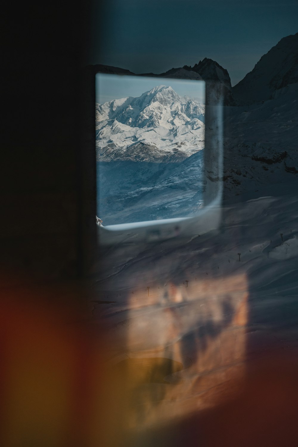 black flat screen tv turned on displaying snow covered mountain