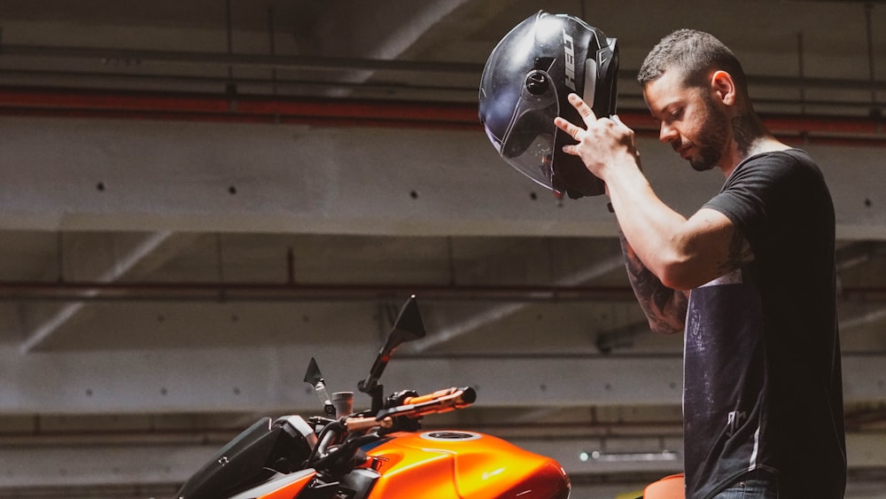 man in orange helmet riding orange motorcycle