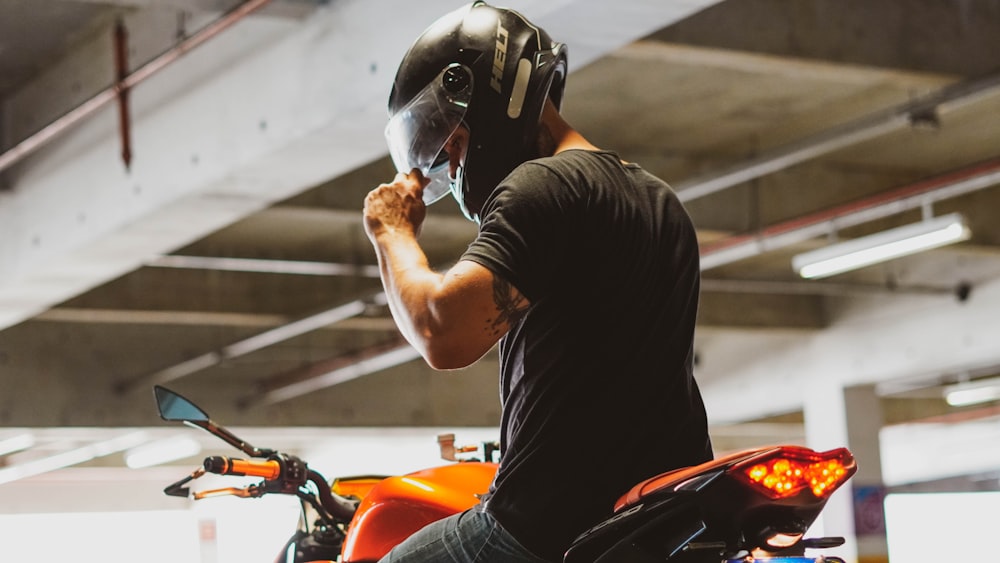 man in black t-shirt wearing helmet