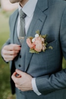 man in black suit holding bouquet of flowers