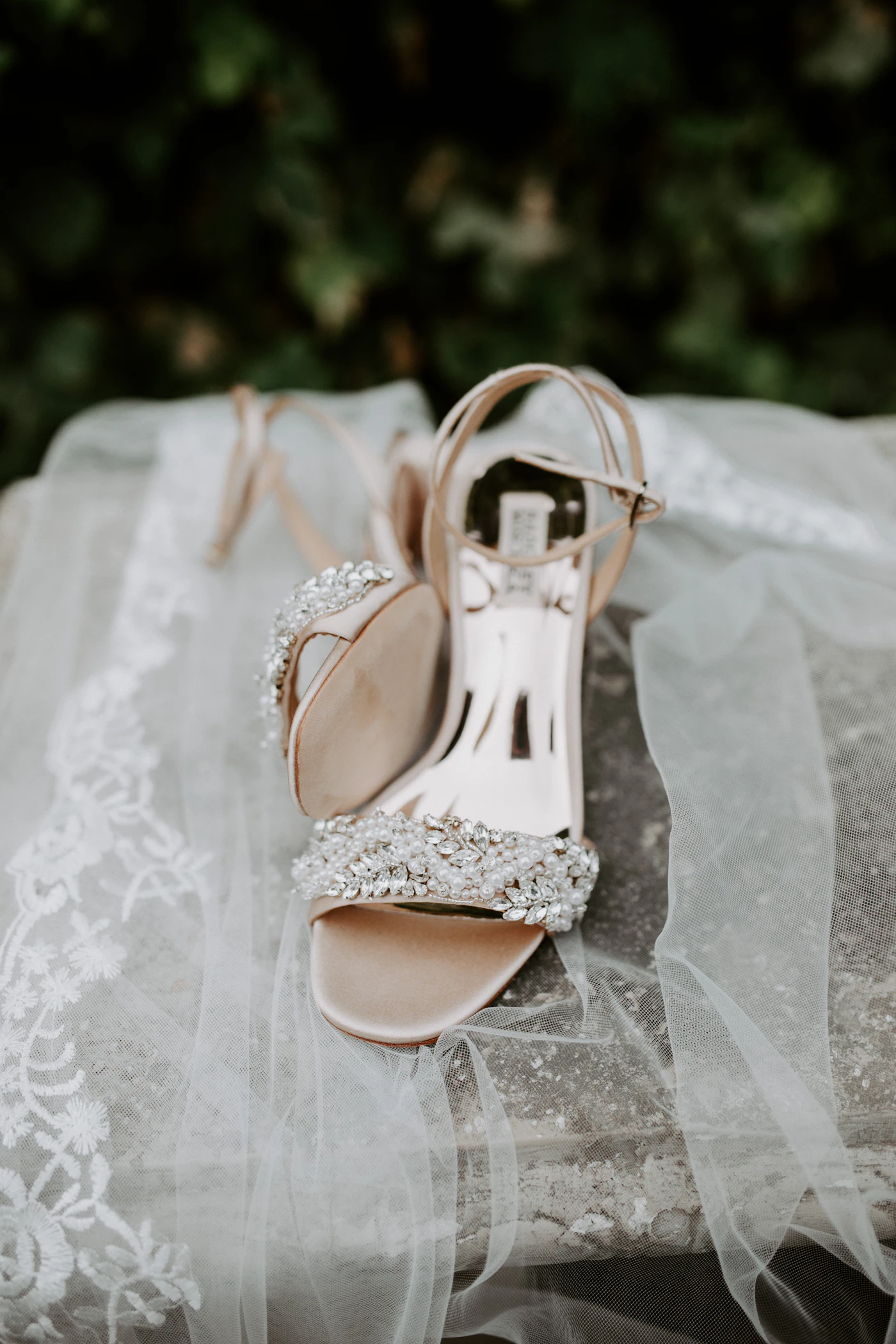 Best websites for custom-made bridal shoes — A bride holding her bouquet with custom heels peeking out