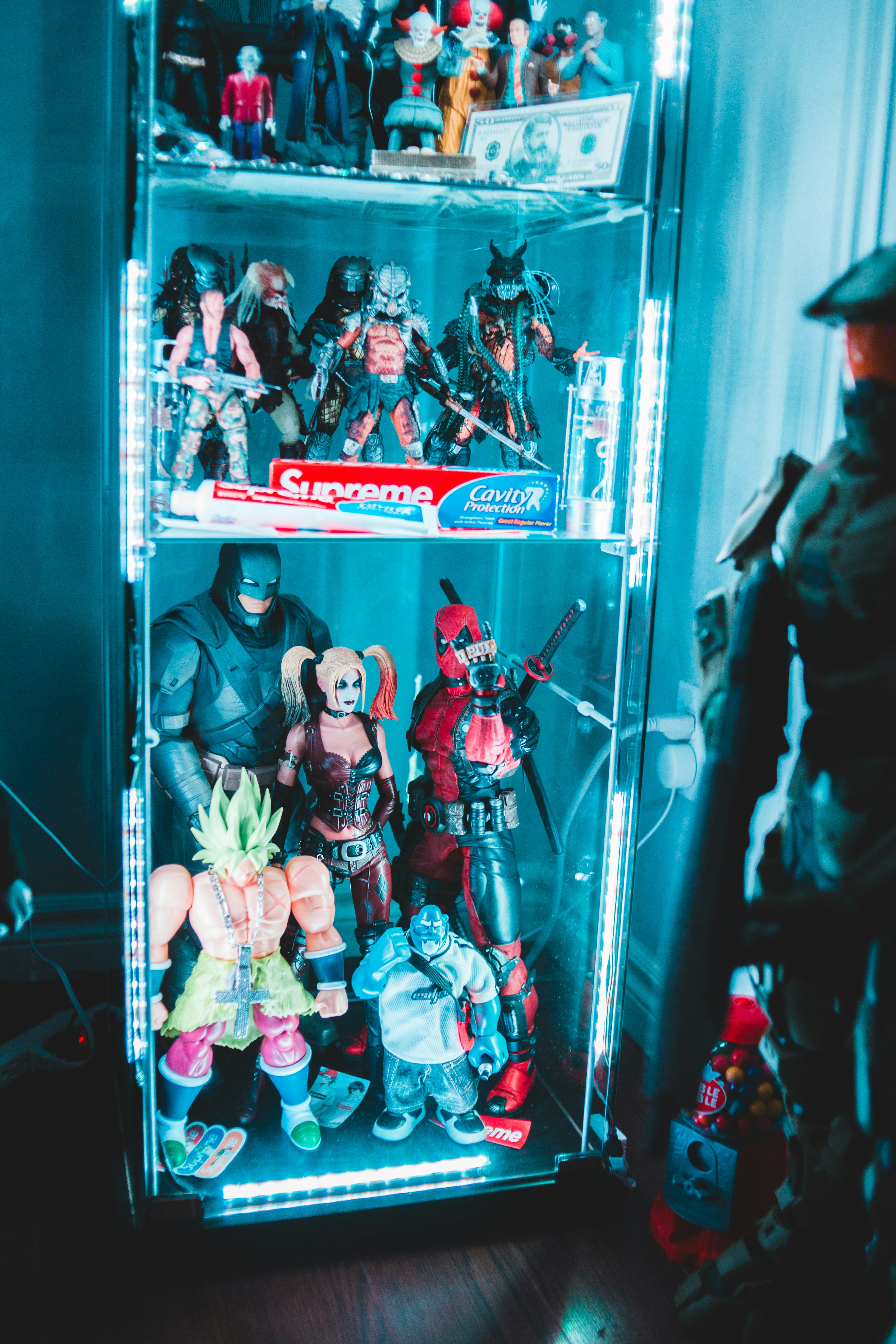Video game character action figures from popular gaming franchises in neon-lit display
