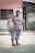 man in red and white stripe crew neck t-shirt holding fish