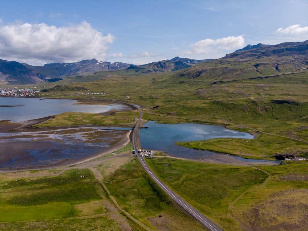 an aerial view of a road and a body of water