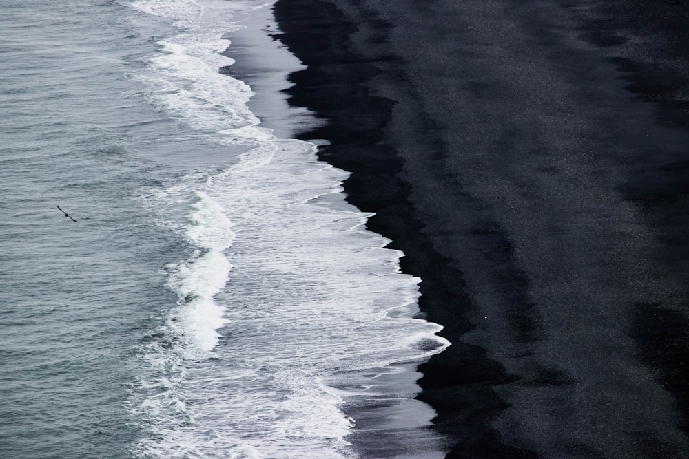 ocean waves crashing on shore during daytime