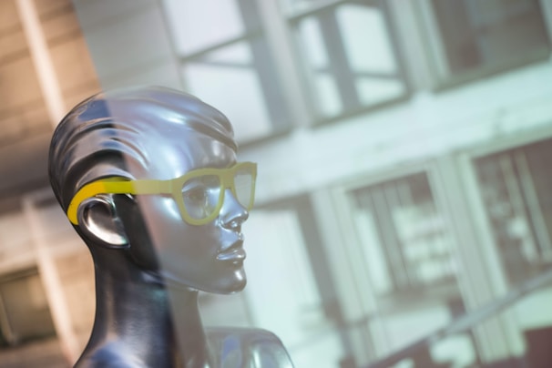 Close-up of a Maison Madonna eyewear piece with dark geometric frames reflecting a mysterious cityscape.