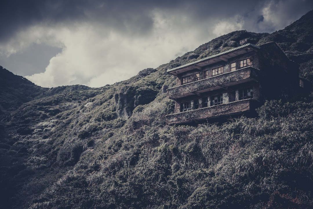 brown concrete building on top of mountain
