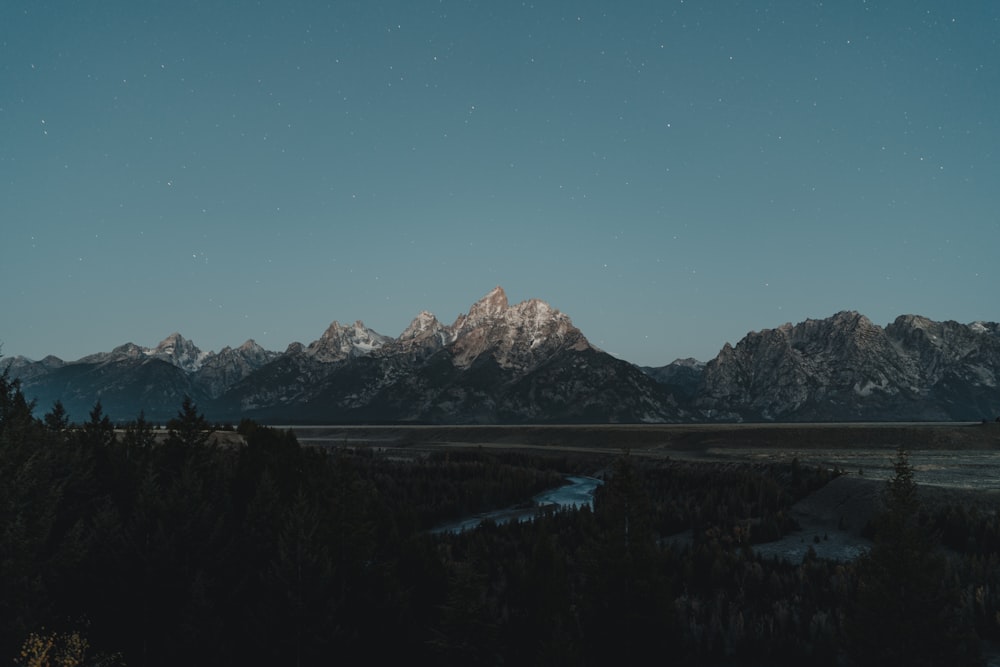 a view of a mountain range with a river in the foreground