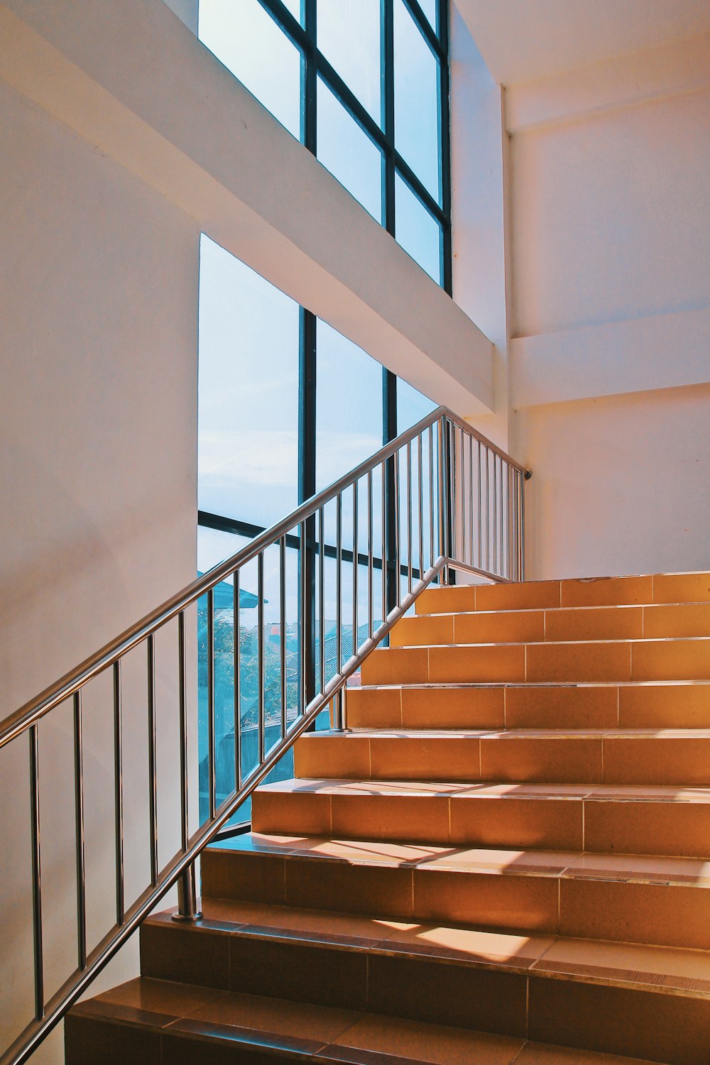 brown wooden staircase near body of water during daytime