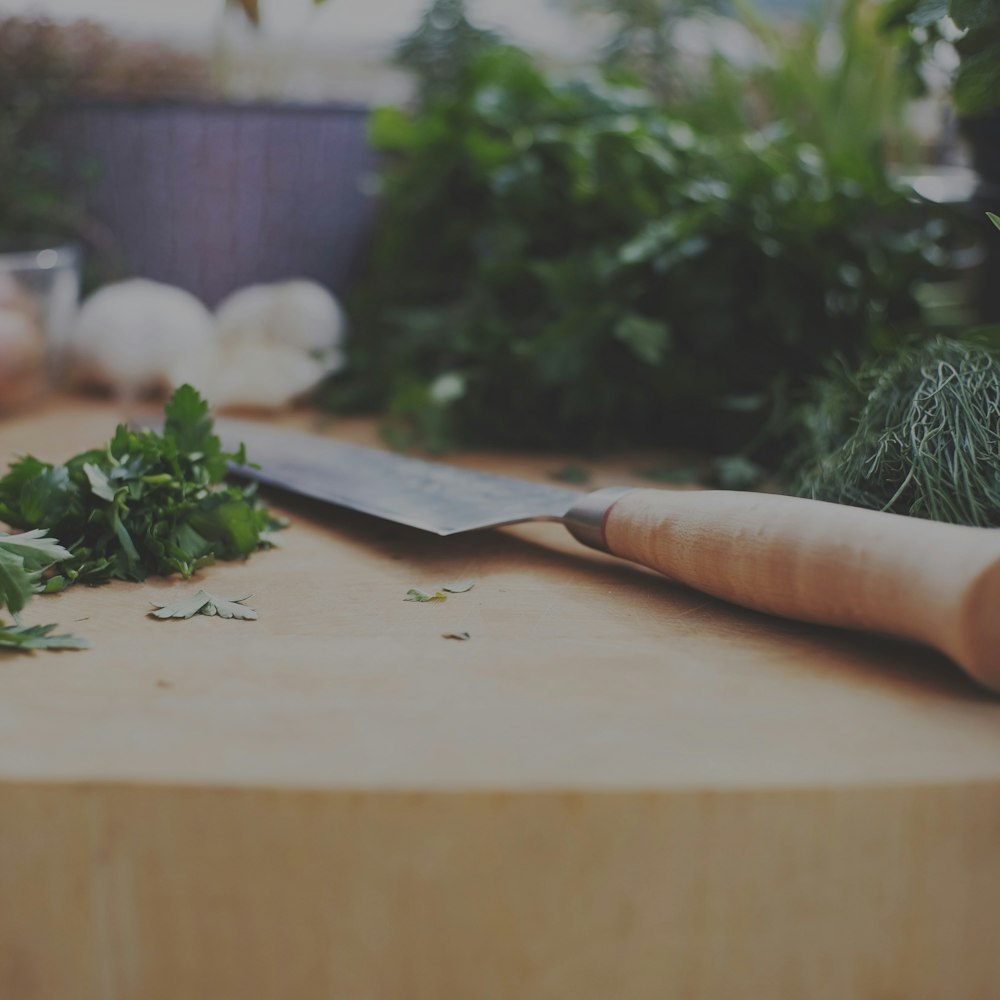 brown wooden handled knife on brown wooden chopping board